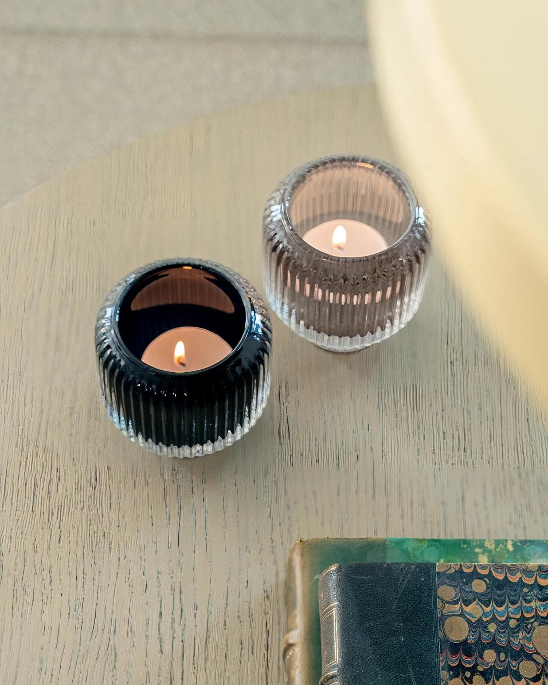 Chandelle Storms candle holders in black and taupe, shown in a lifestyle top view as image 5