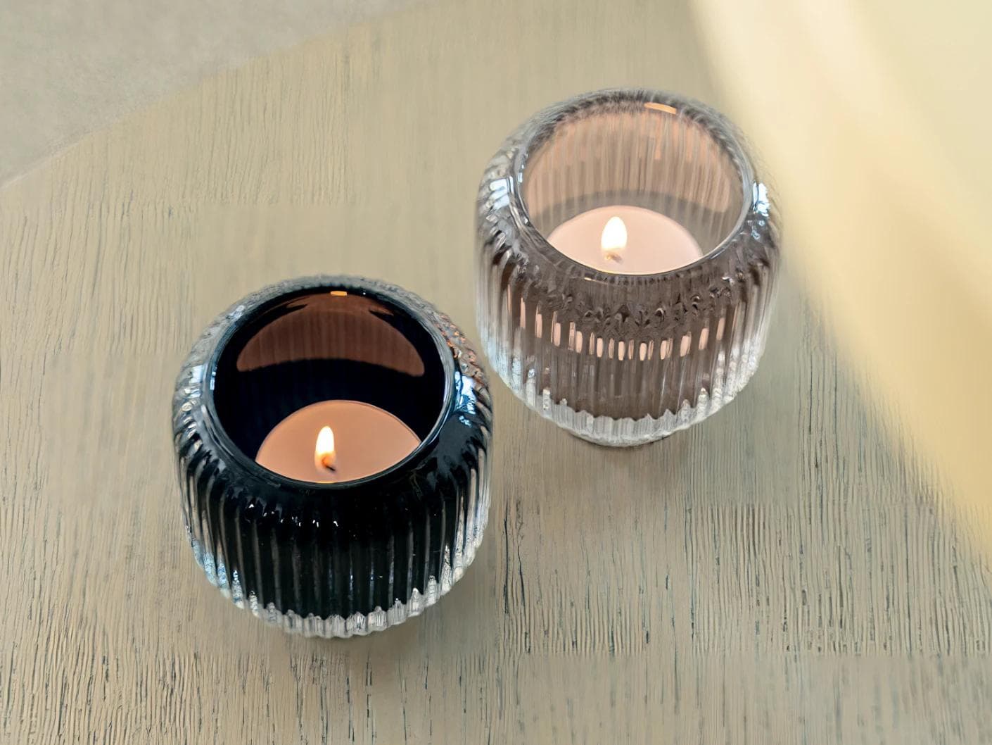 Chandelle Storms candle holders in black and taupe, shown in a lifestyle top view as image 5