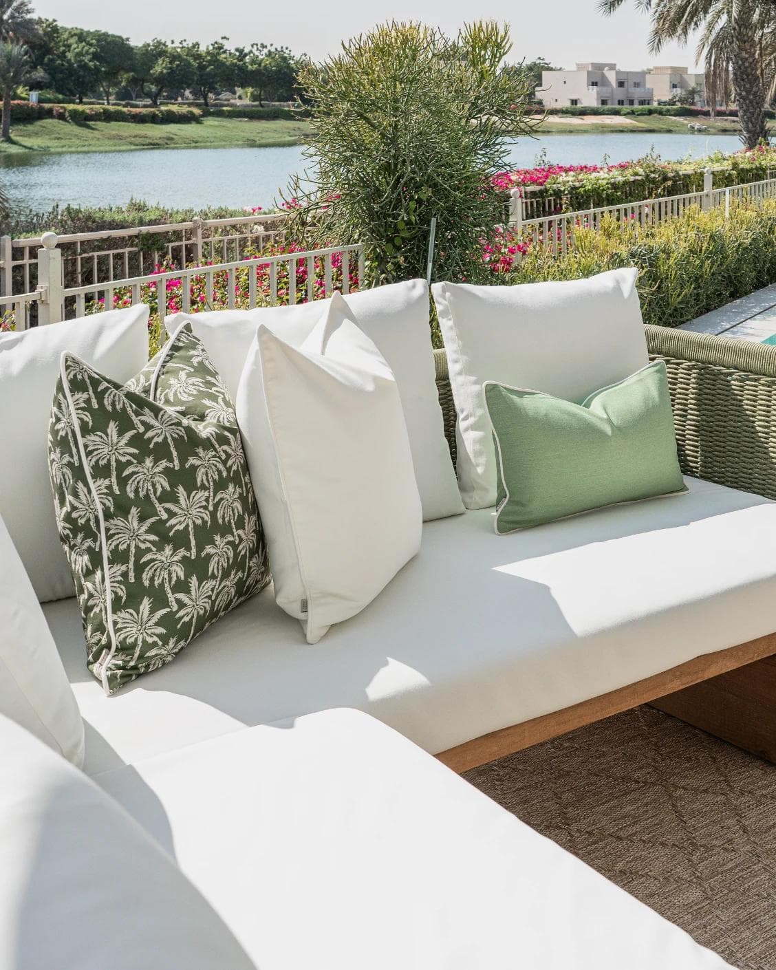 Chaya Bundle cushion in green and ivory, shown in a lifestyle left view as image 2