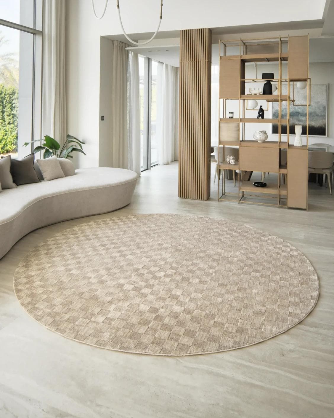 Cindy Dune Round carpet in taupe and beige, shown in a lifestyle front view
