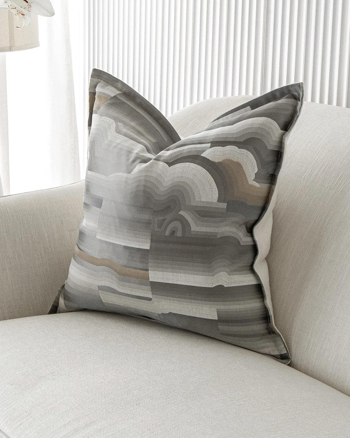Claudine Laurent cushion in grey, shown in a lifestyle front view as image 2