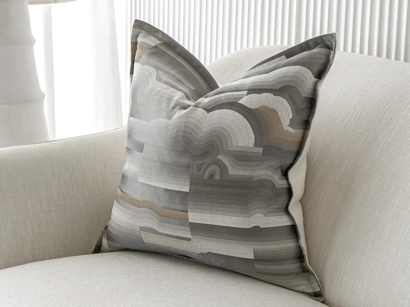 Claudine Laurent cushion in grey, shown in a lifestyle front view as image 2