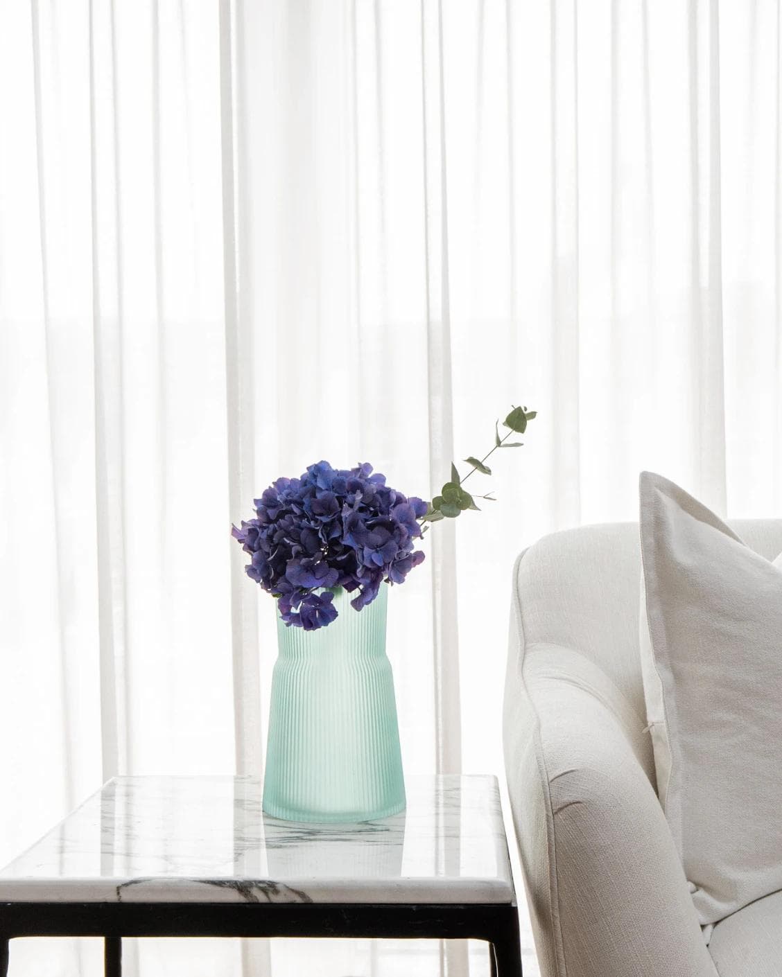 Cloris Storms vases in turquoise, shown in a lifestyle front view as image 4
