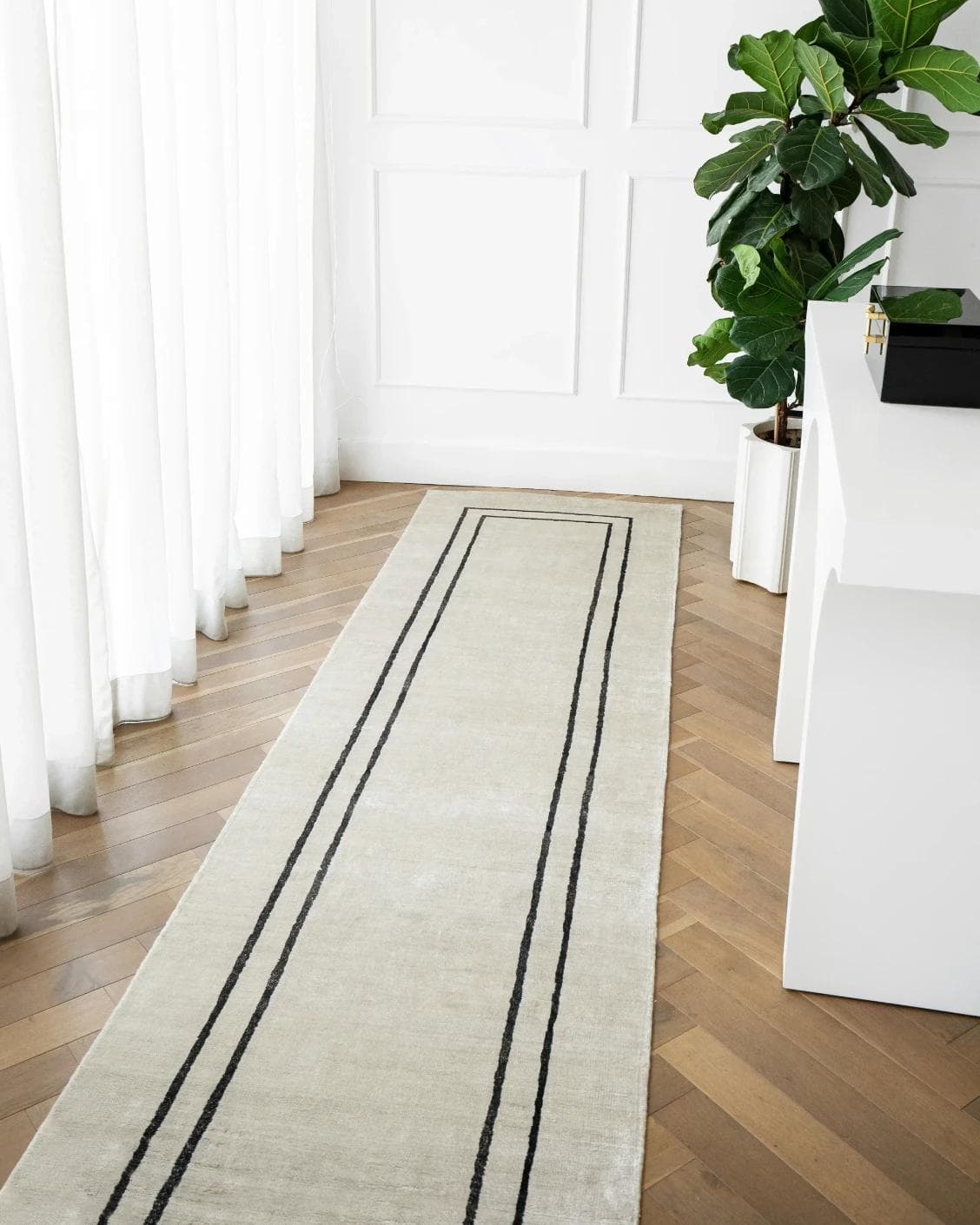 Colin Bianca Runners carpet in white, black and pearl, shown in a lifestyle front view