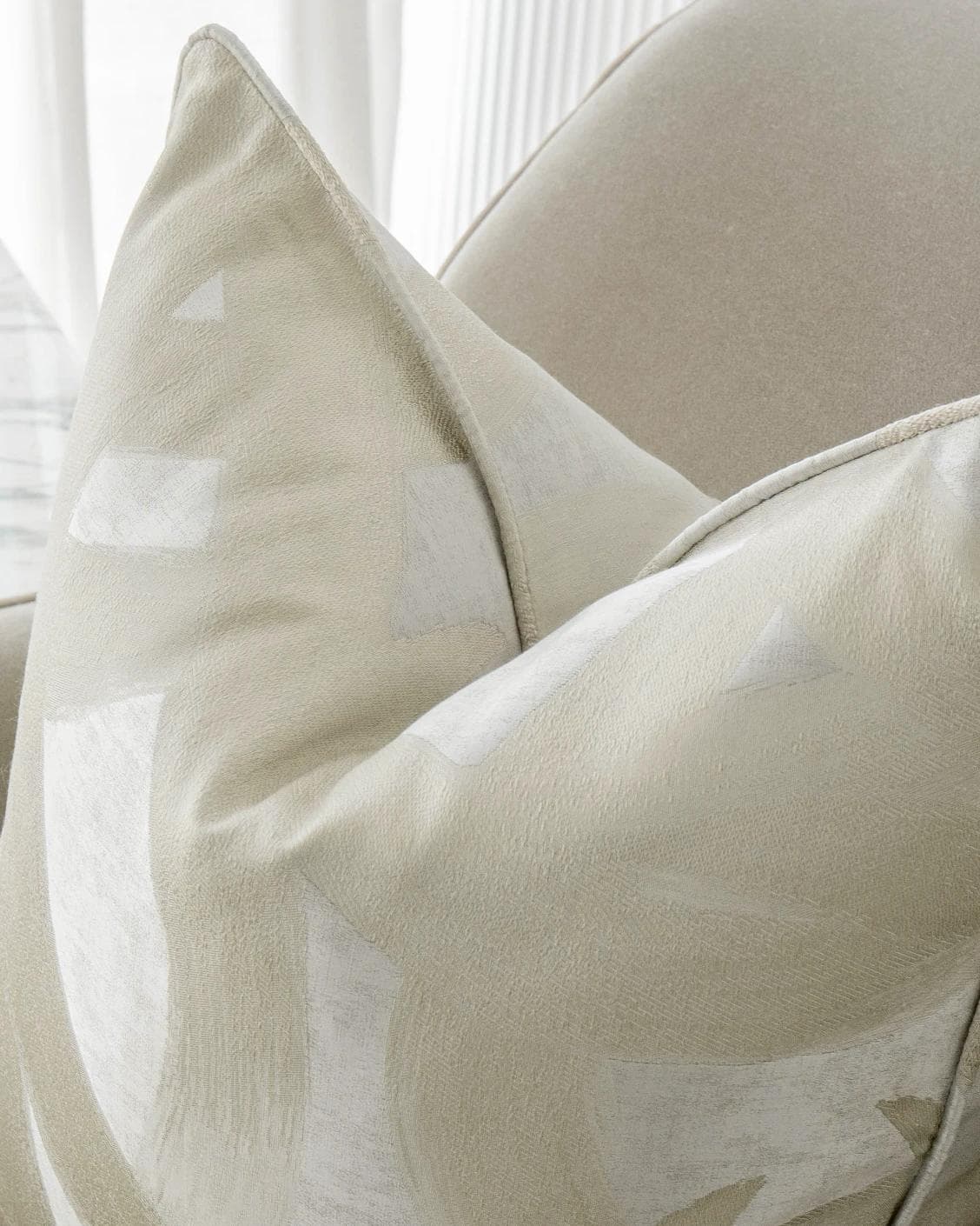 Danya Laurent cushion in silver and beige, shown in a lifestyle top view as image 5