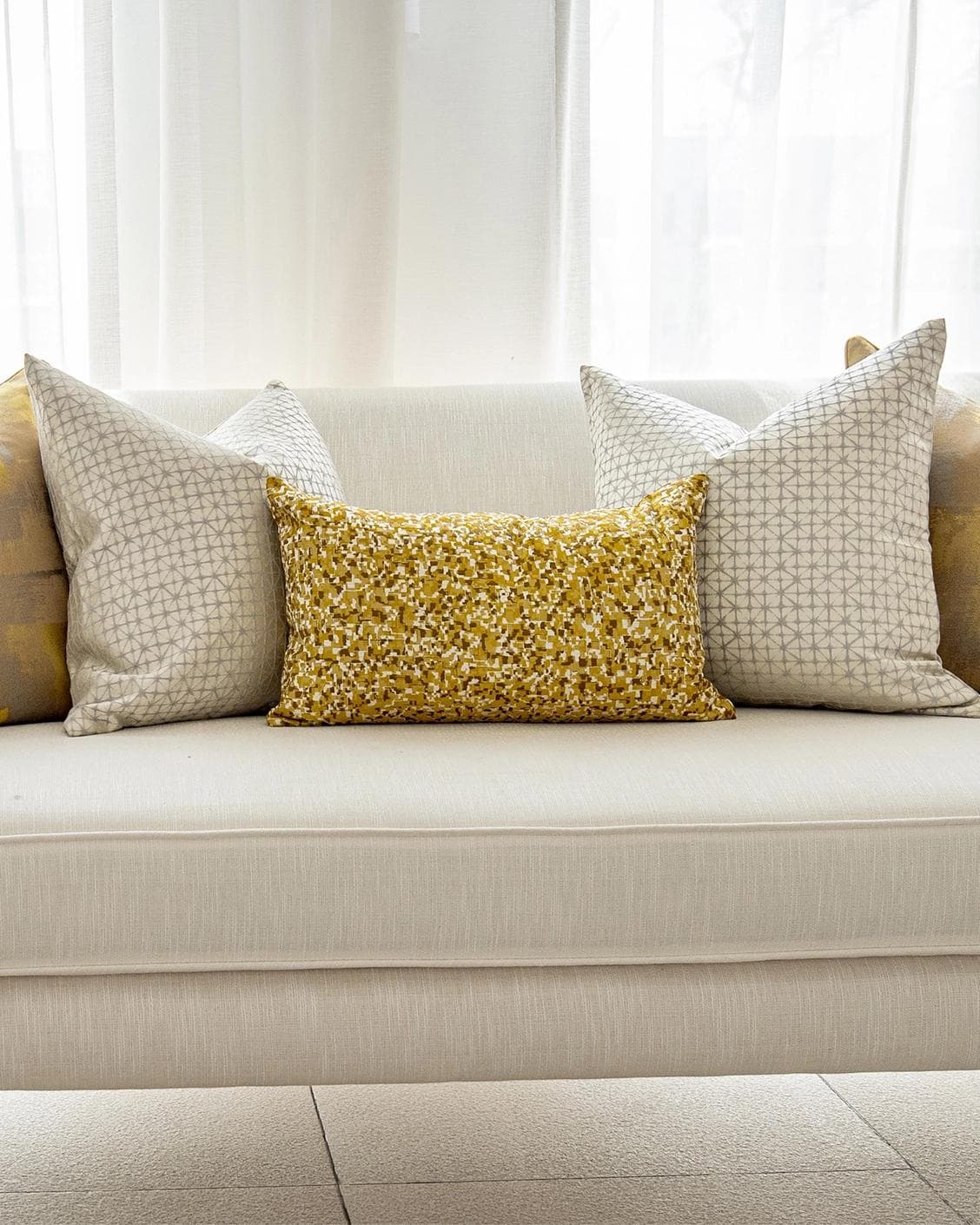 Ivan Bundle cushion in gold and silver, shown in a lifestyle front view as image 4