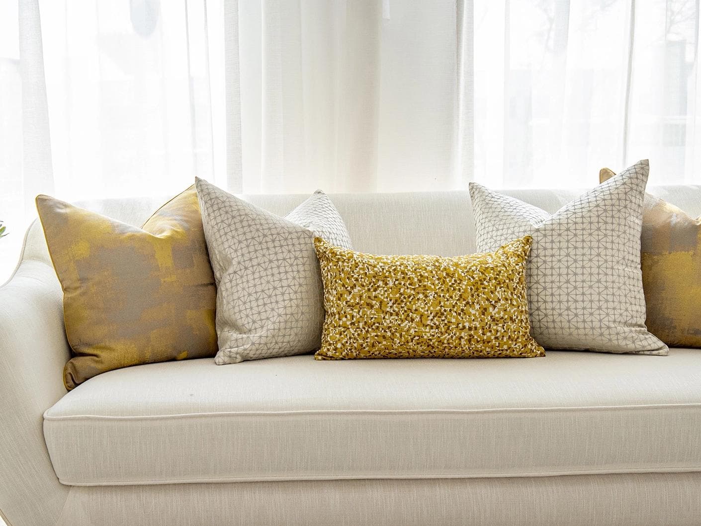 Ivan Bundle cushion in gold and silver, shown in a lifestyle front view as image 4