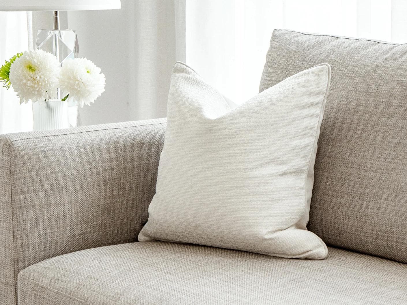Divina Bianca cushion in white, shown in a lifestyle front view as image 2