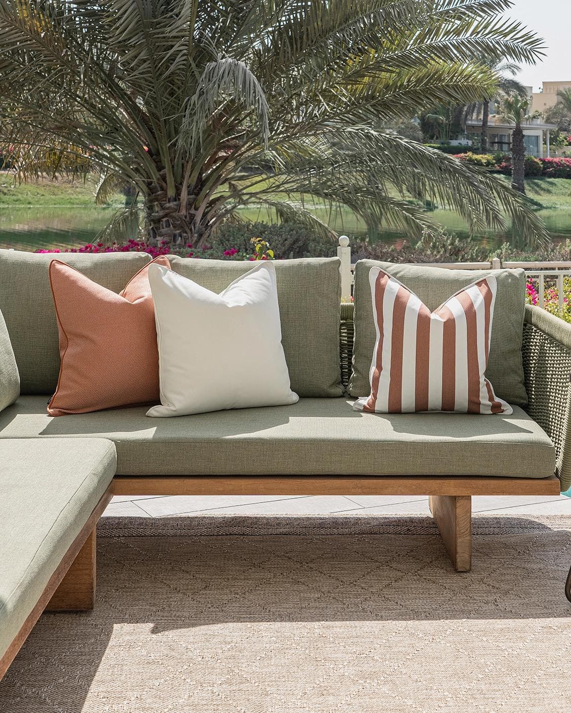 Donya Bundle cushion in ivory and rust, shown in a lifestyle front view as image 4