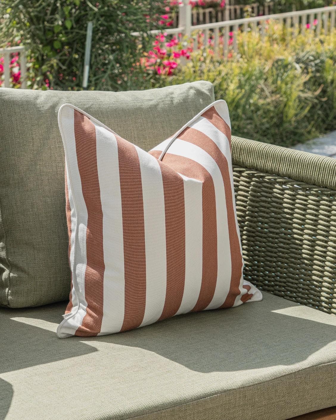 Donya Bundle cushion in ivory and rust, shown in a lifestyle left view as image 5