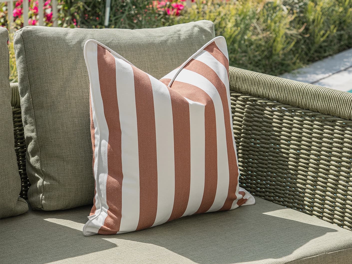 Donya Bundle cushion in ivory and rust, shown in a lifestyle left view as image 5