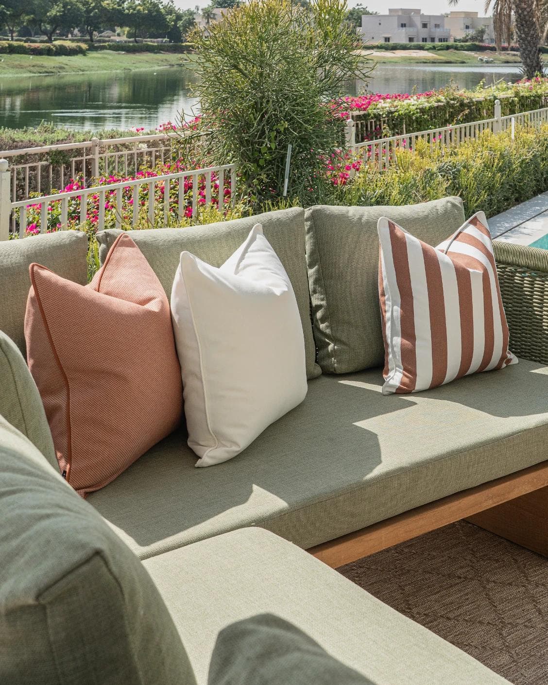 Donya Bundle cushion in ivory and rust, shown in a lifestyle left view as image 2