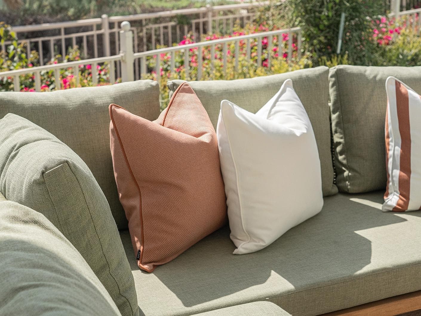 Donya Bundle cushion in ivory and rust, shown in a lifestyle left view as image 6