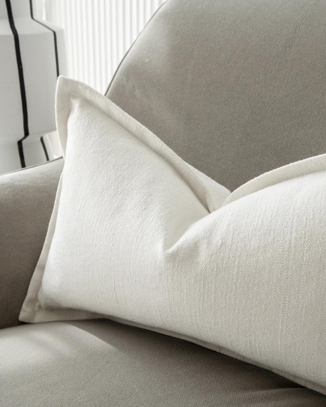 Dorothy Bianca II cushion in white, shown in a lifestyle right view as image 6