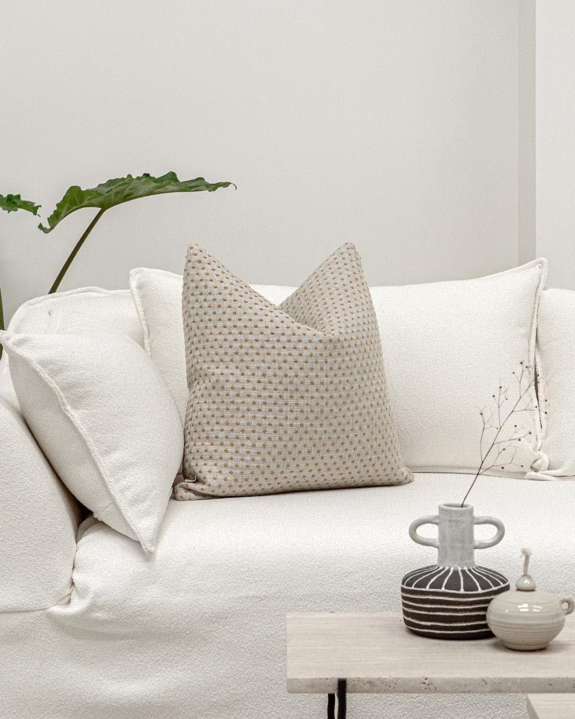 Dotty Barrymore cushion in beige, shown in a lifestyle front view as image 4