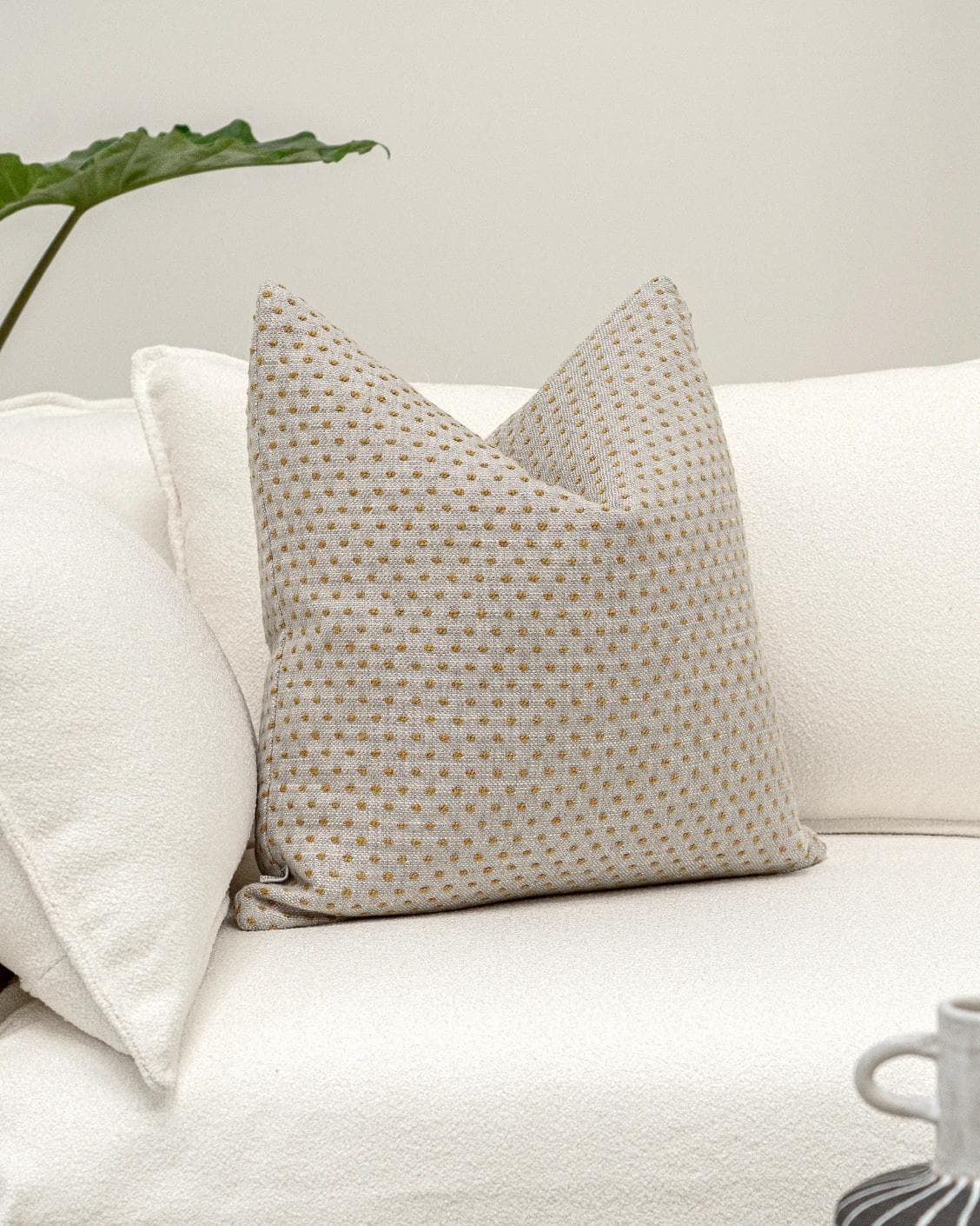 Dotty Barrymore cushion in beige, shown in a lifestyle front view as image 2