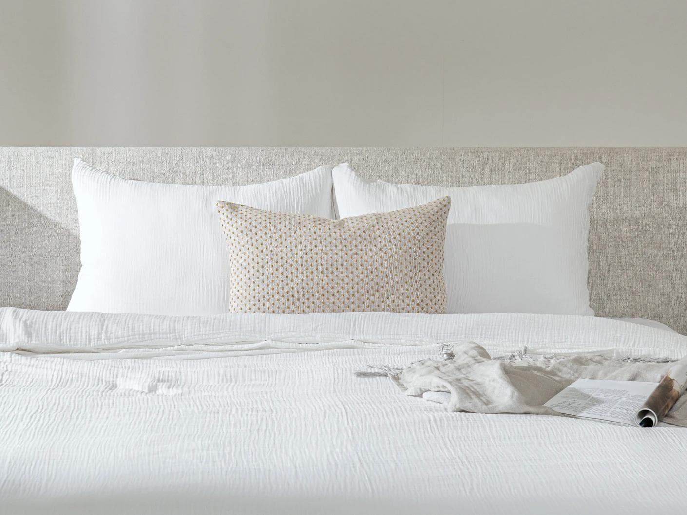 Dotty Barrymore III cushion in beige and grey, shown in a lifestyle front view as image 3