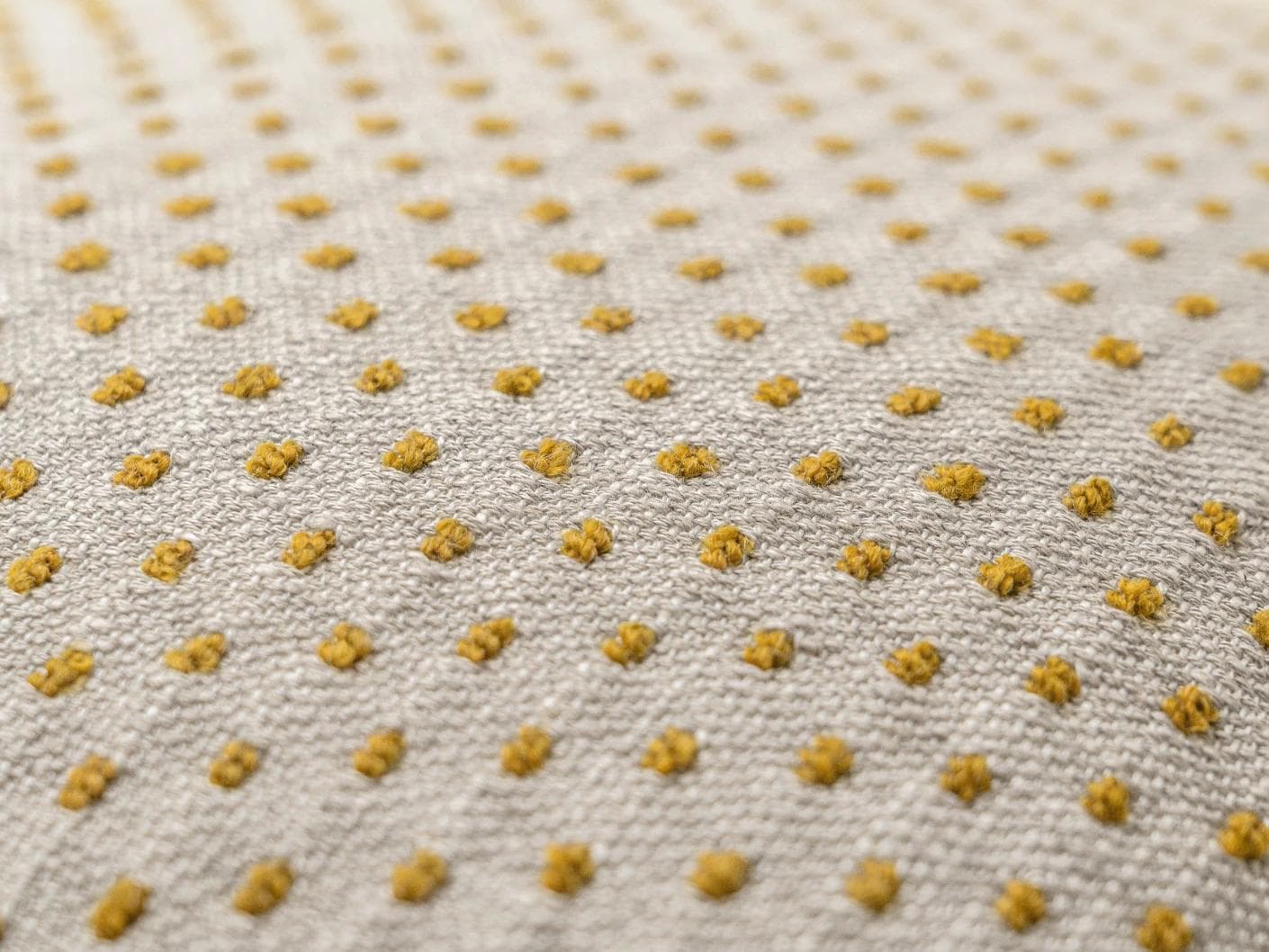Dotty Barrymore III cushion in beige and grey, shown in a product close-up top view as image 2