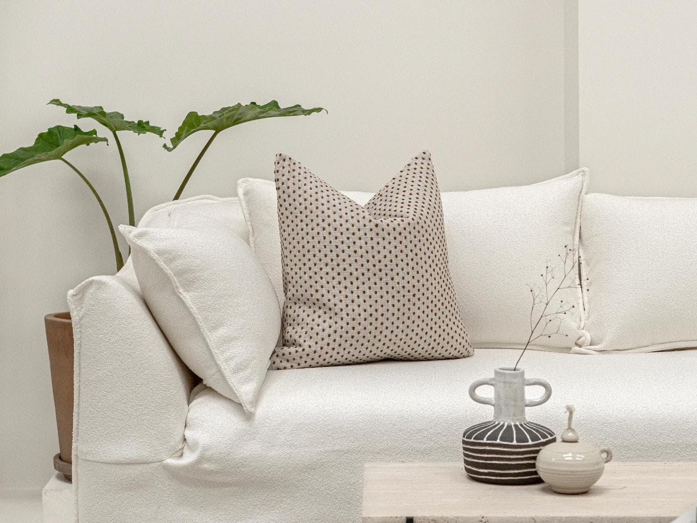 Dotty Rust cushion in beige, shown in a lifestyle front view as image 4
