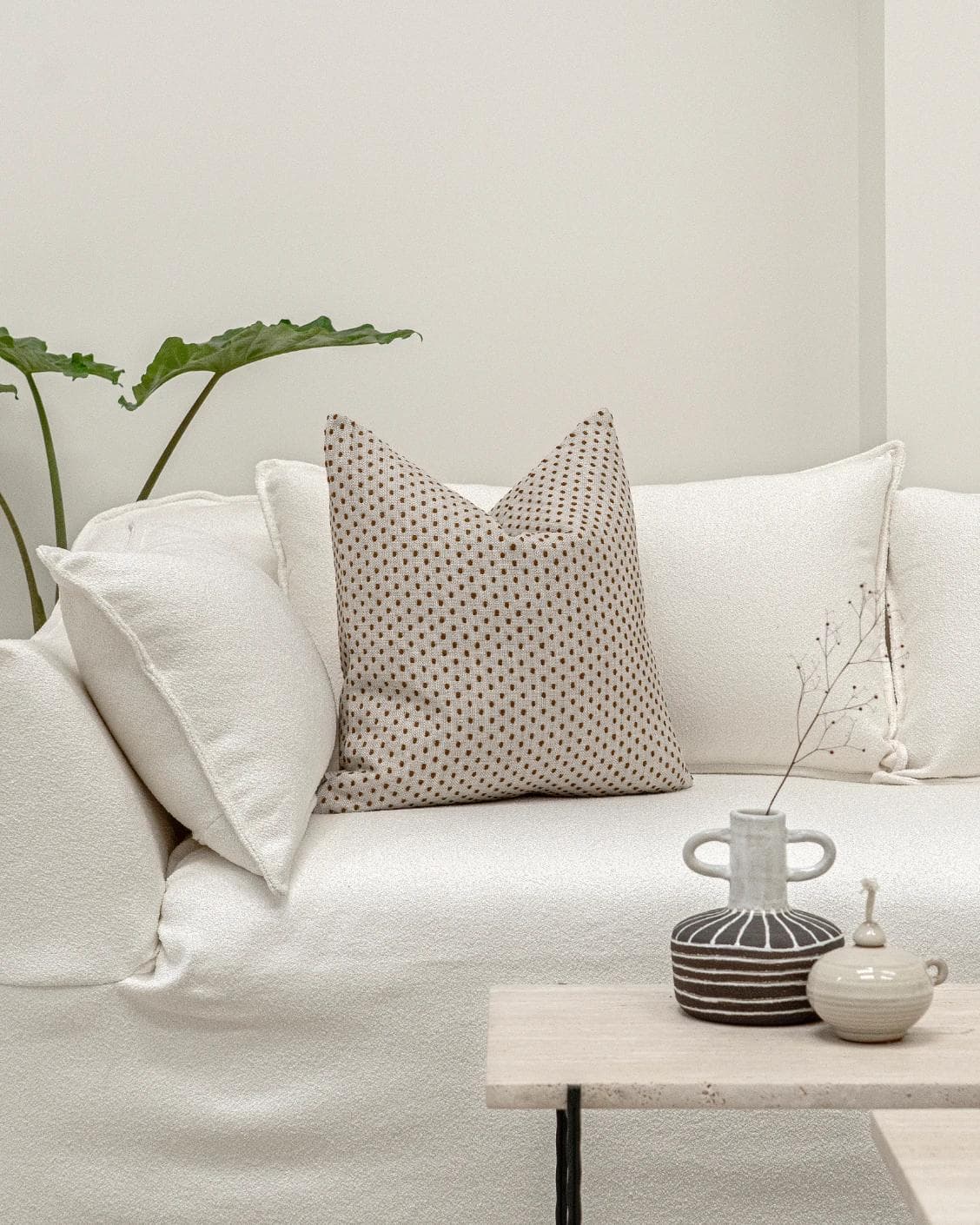 Dotty Rust cushion in beige, shown in a lifestyle front view as image 4