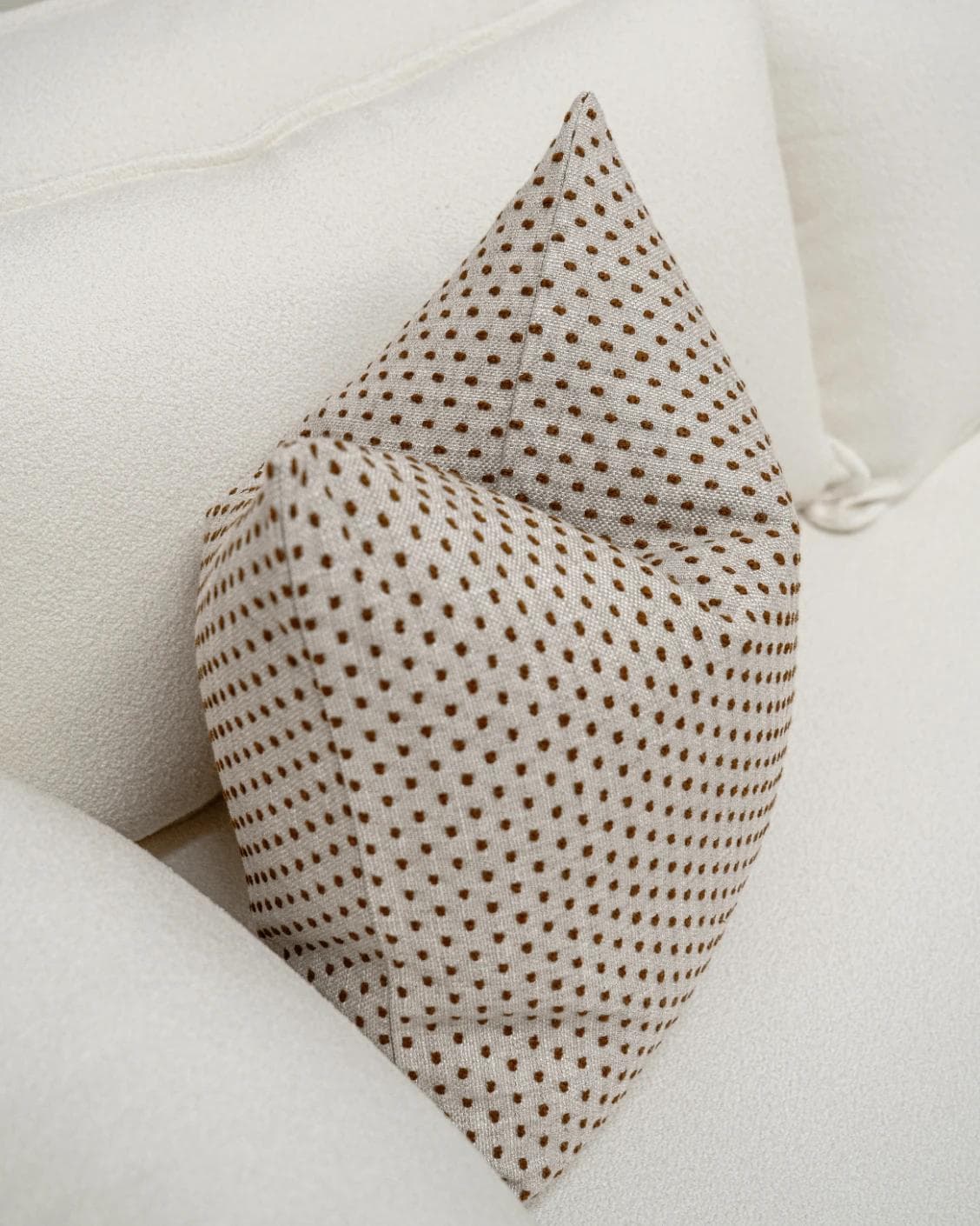 Dotty Rust cushion in beige, shown in a lifestyle top view as image 5