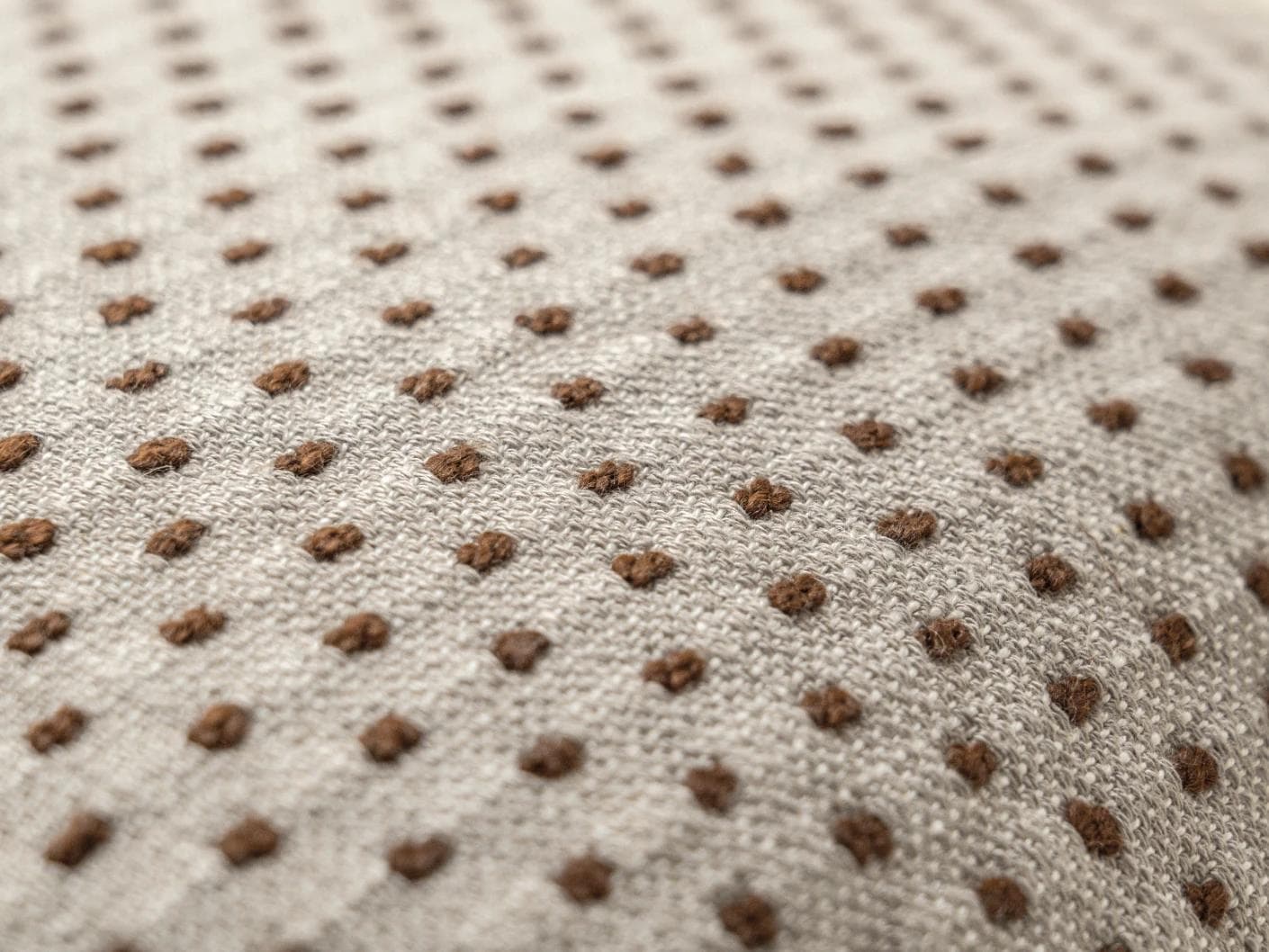 Dotty Rust cushion in beige, shown in a product close-up as image 6