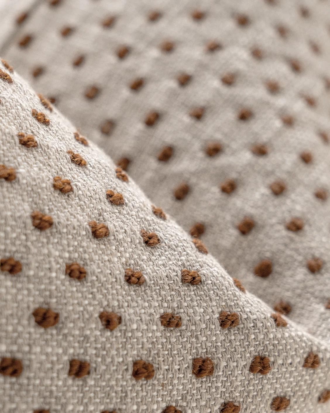 Dotty Rust cushion in beige, shown in a product close-up as image 7