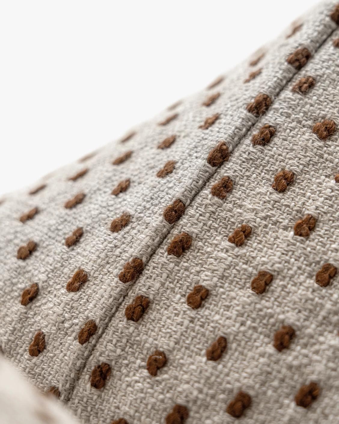 Dotty Rust cushion in beige, shown in a product close-up as image 8