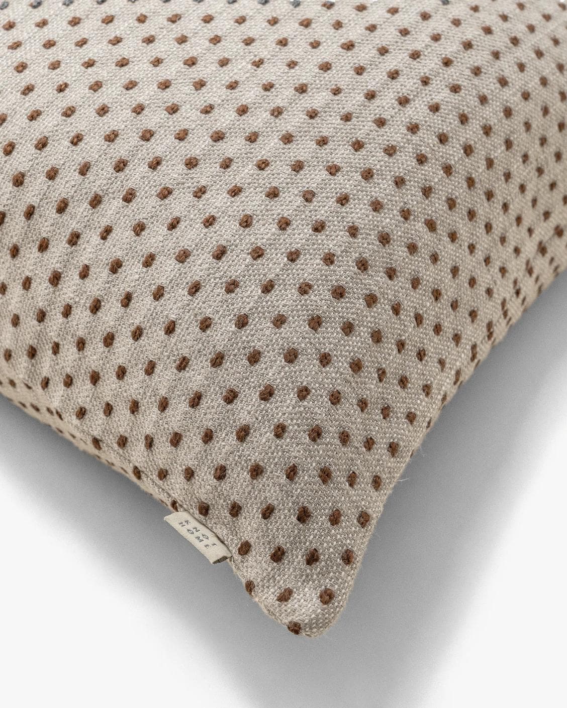 Dotty Rust cushion in beige, shown in a product top view as image 9