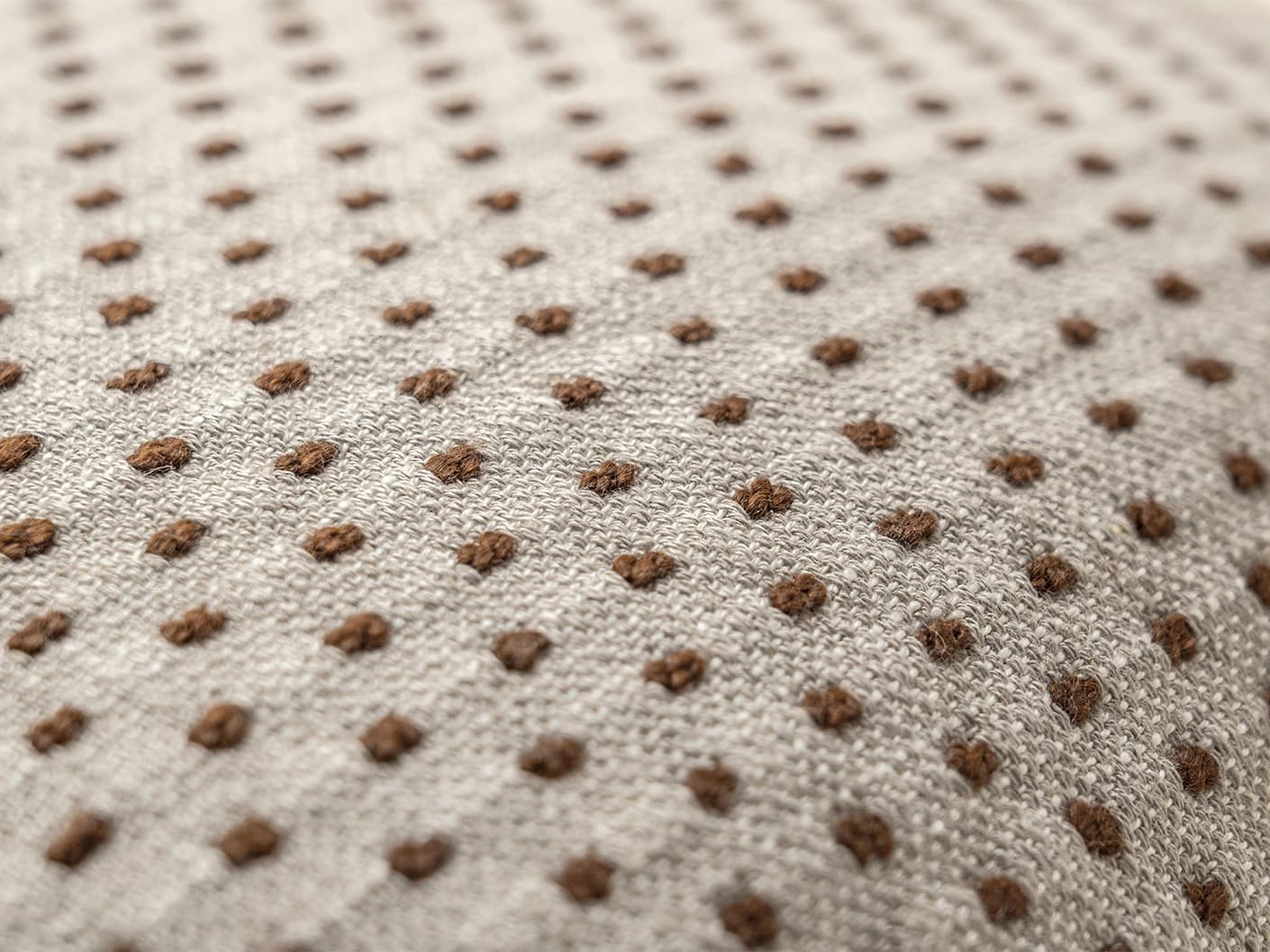 Dotty Rust III cushion in beige and grey, shown in a product close-up top view as image 5