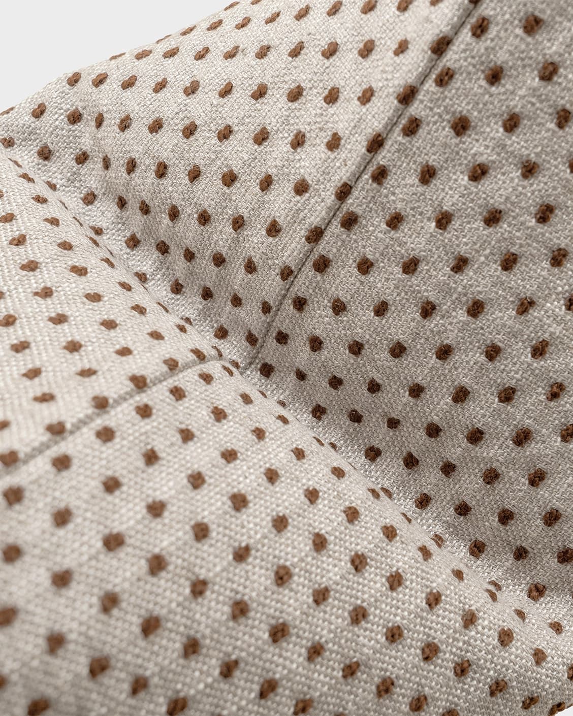 Dotty Rust III cushion in beige and grey, shown in a product close-up top view as image 6