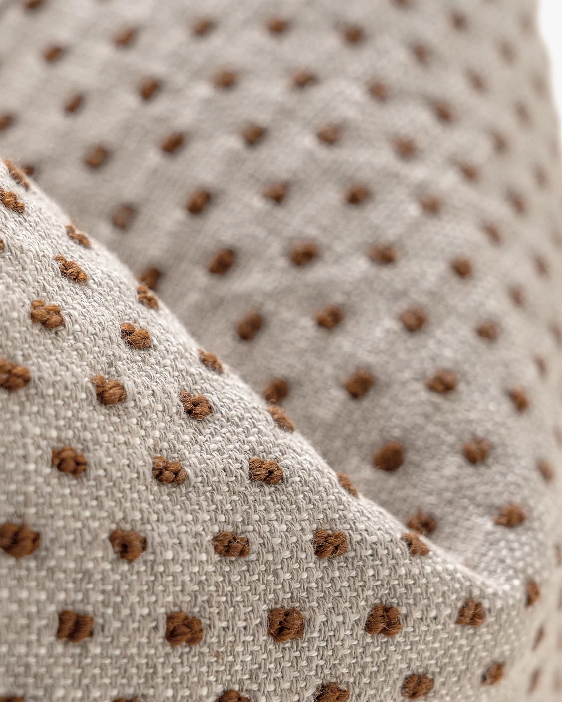 Dotty Rust III cushion in beige and grey, shown in a product left view as image 7