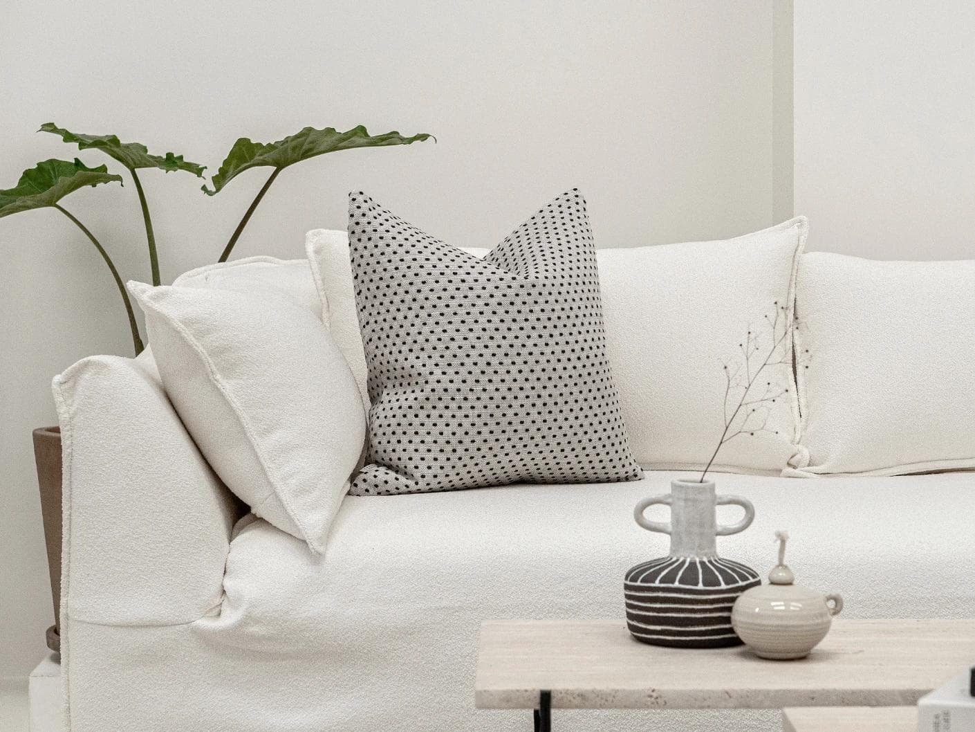 Dotty Steele cushion in grey, shown in a lifestyle front view as image 3