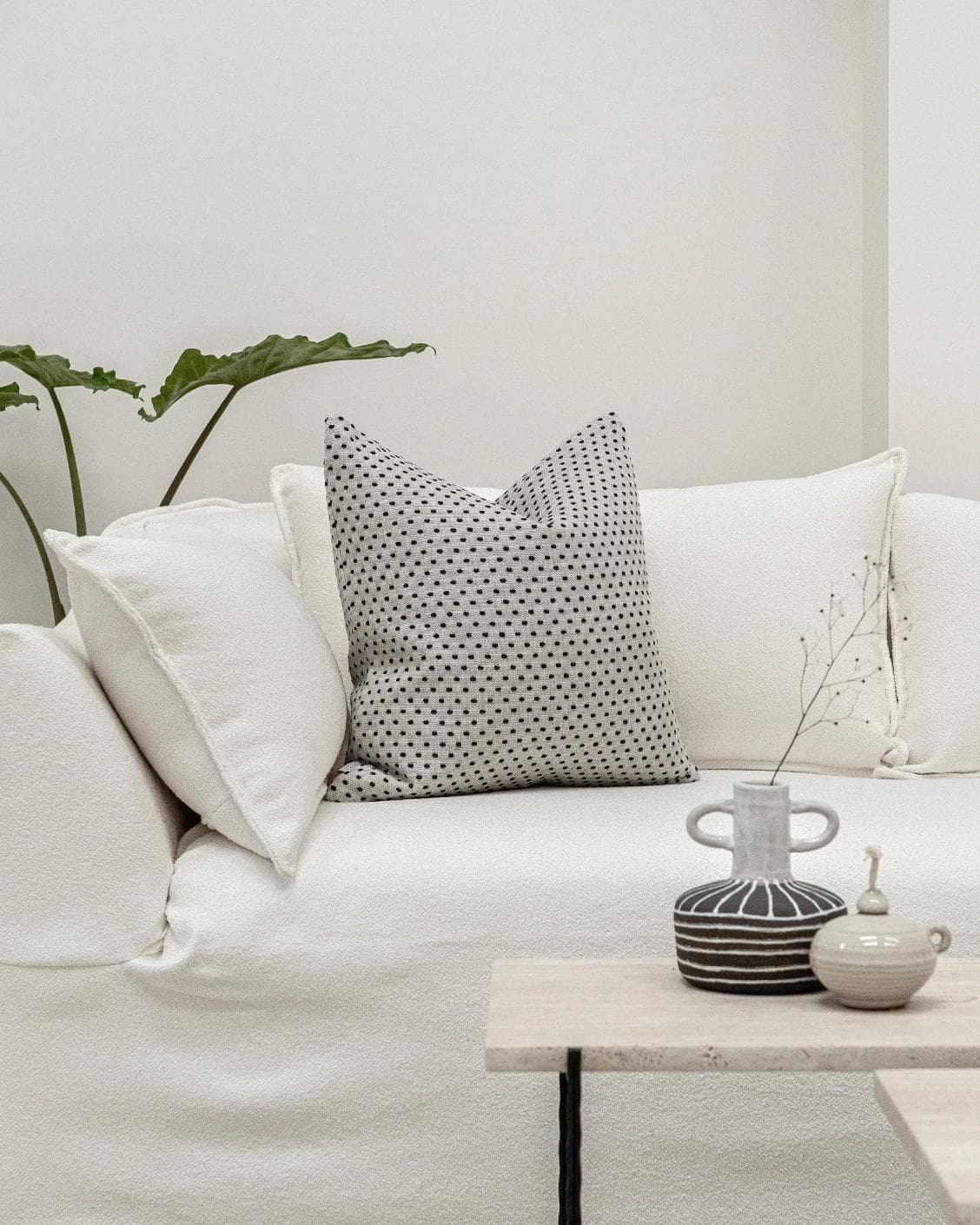 Dotty Steele cushion in grey, shown in a lifestyle front view as image 3