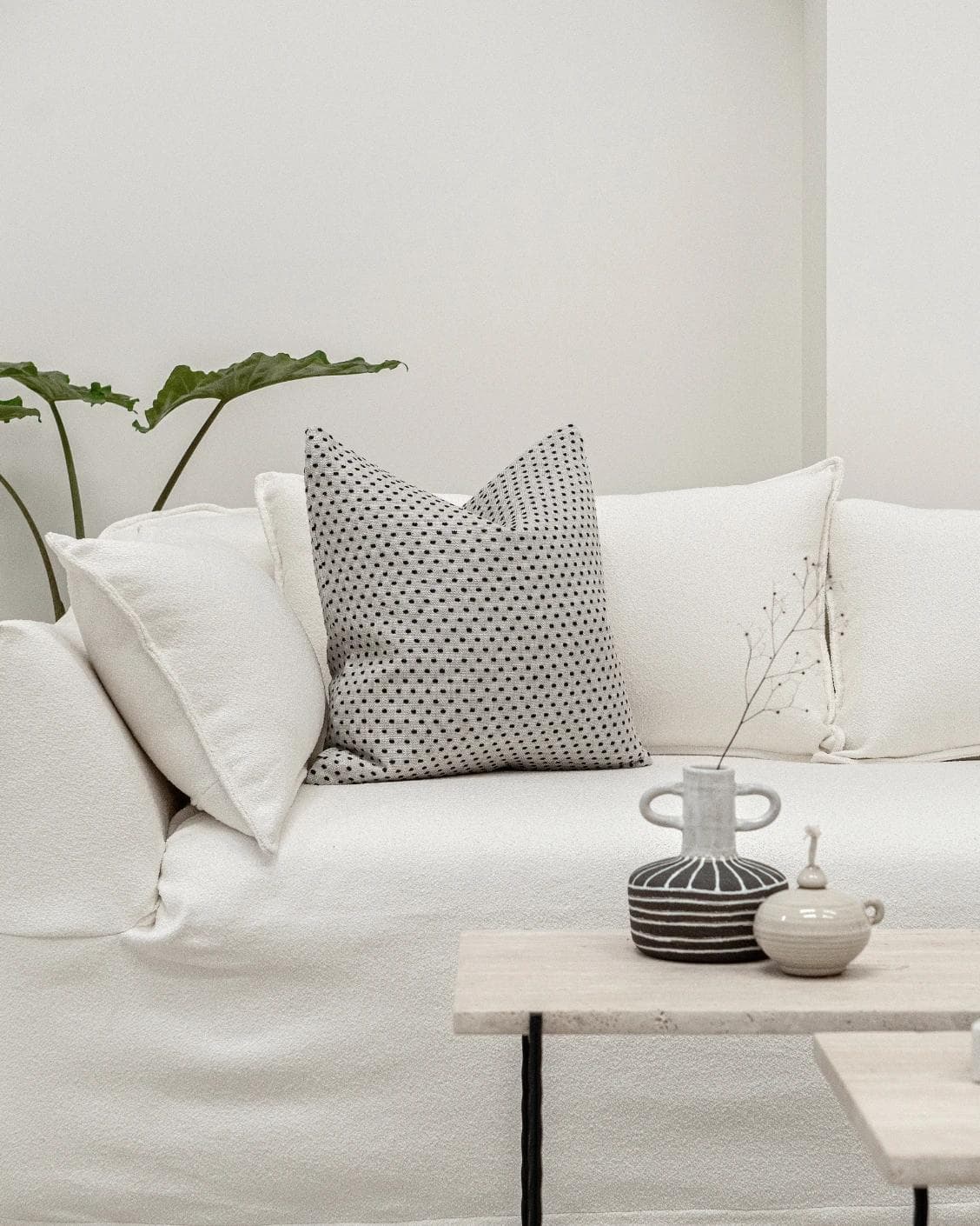 Dotty Steele cushion in grey, shown in a lifestyle front view as image 5