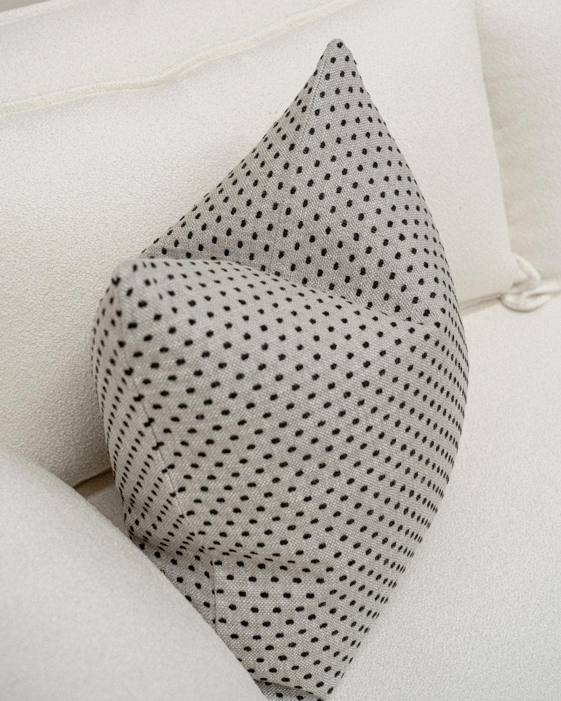 Dotty Steele cushion in grey, shown in a lifestyle front view as image 6