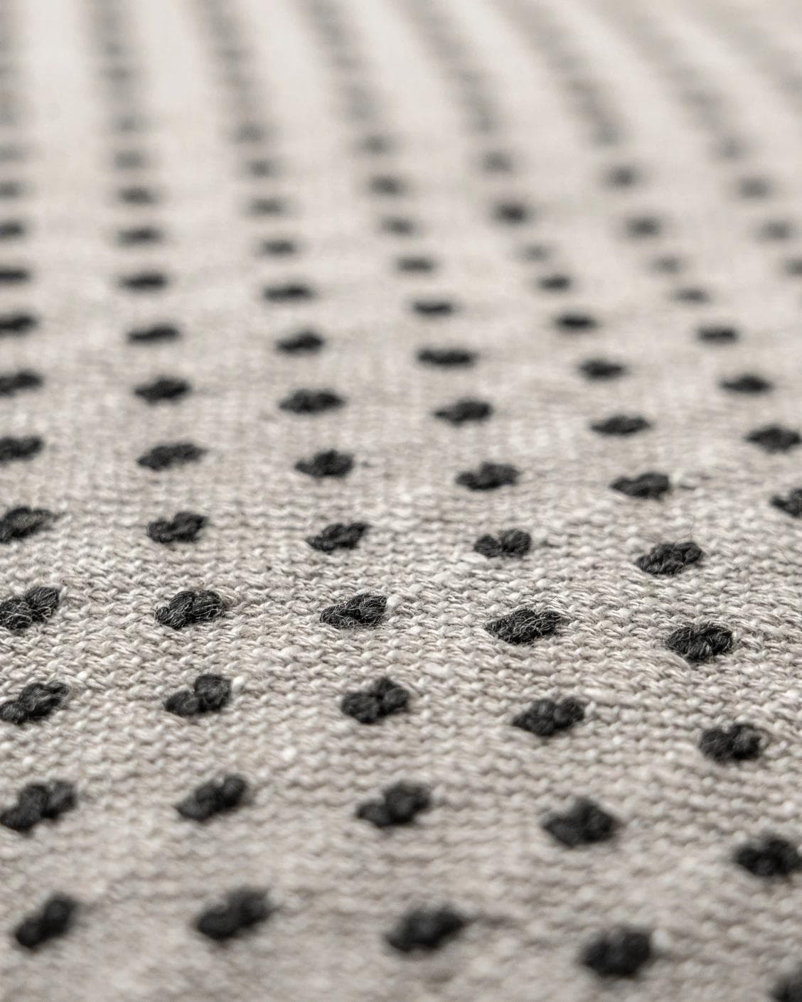 Dotty Steele cushion in grey, shown in a product close-up as image 2