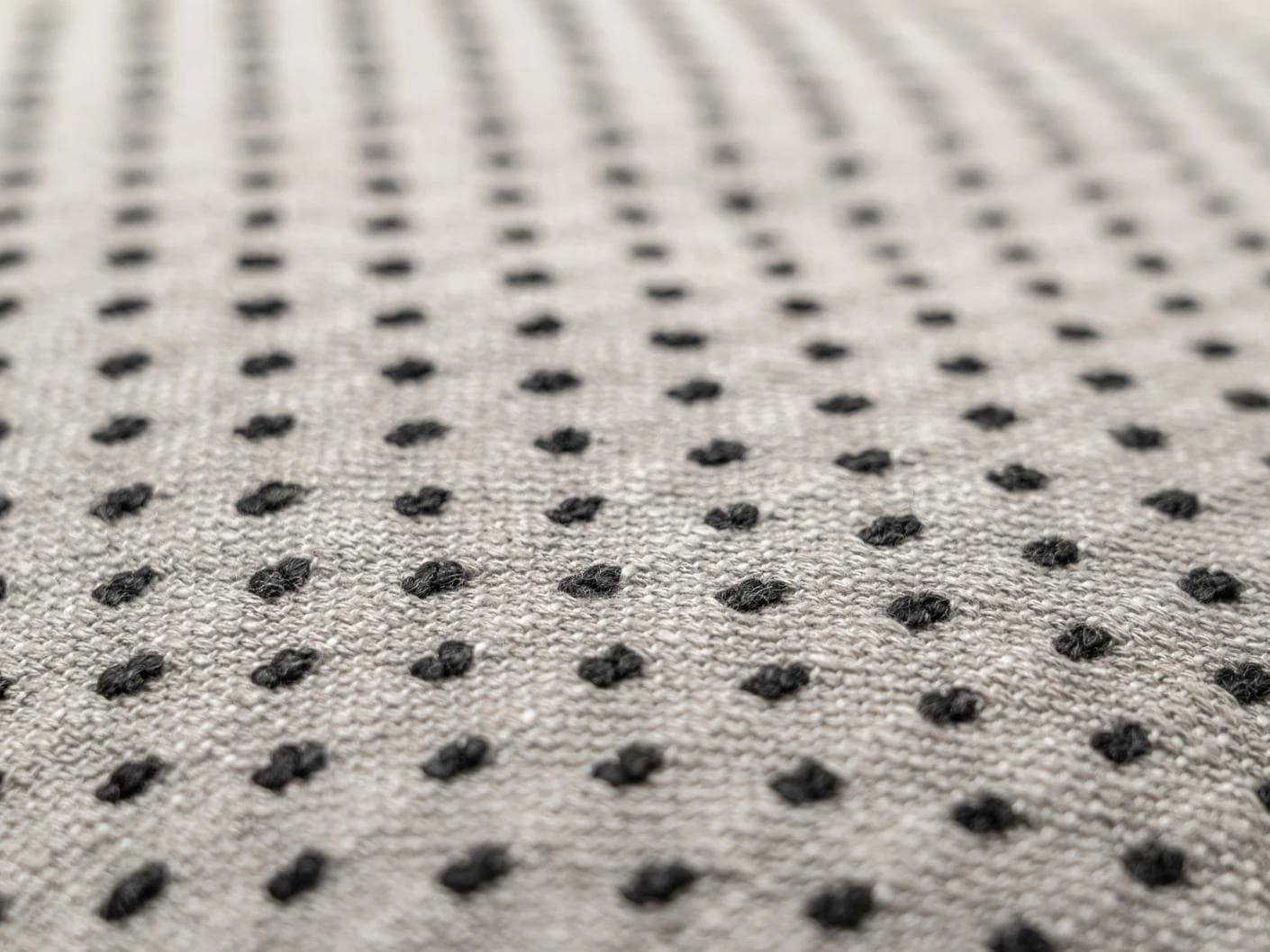 Dotty Steele cushion in grey, shown in a product close-up as image 2