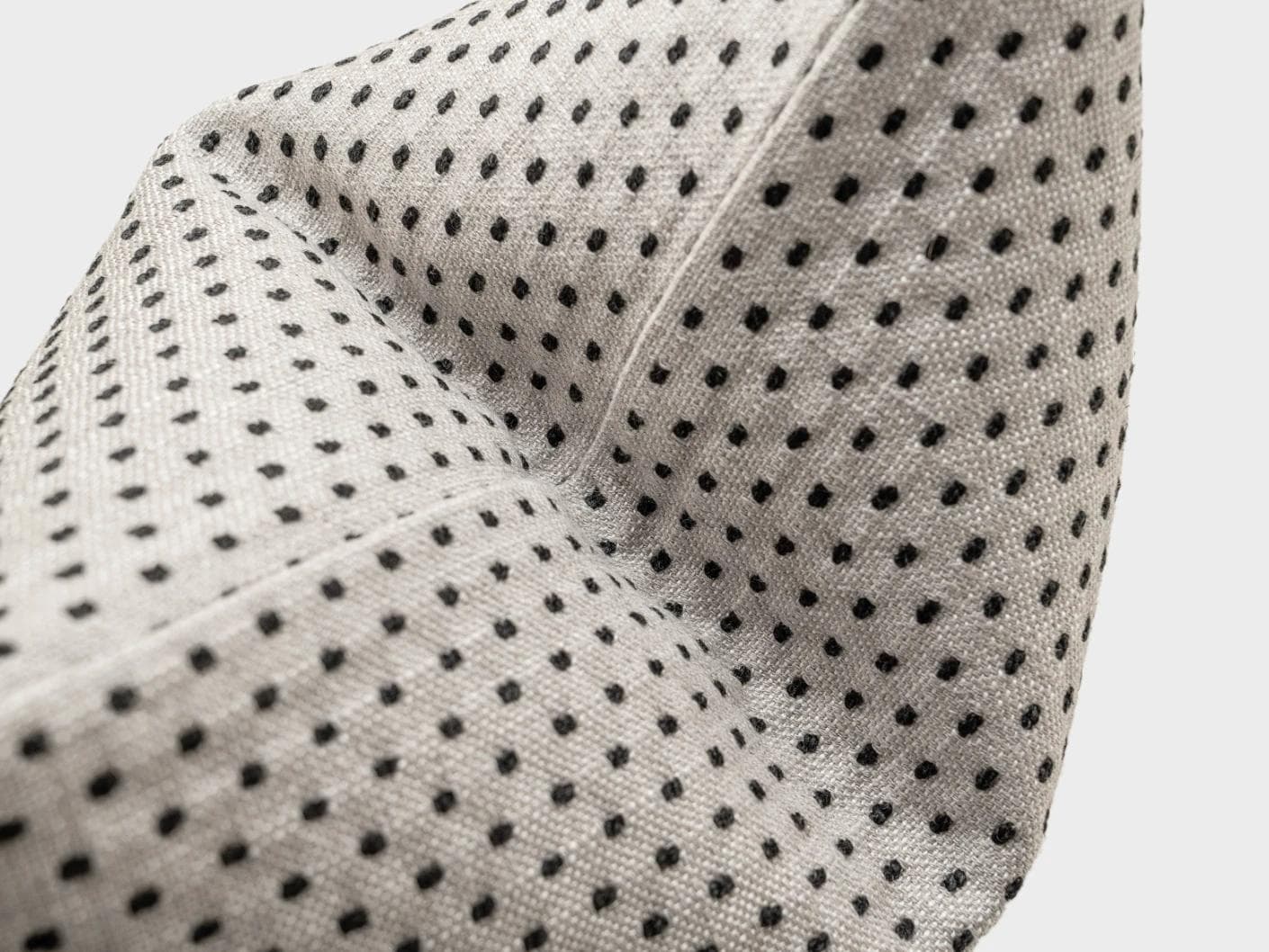 Dotty Steele cushion in grey, shown in a product close-up as image 1
