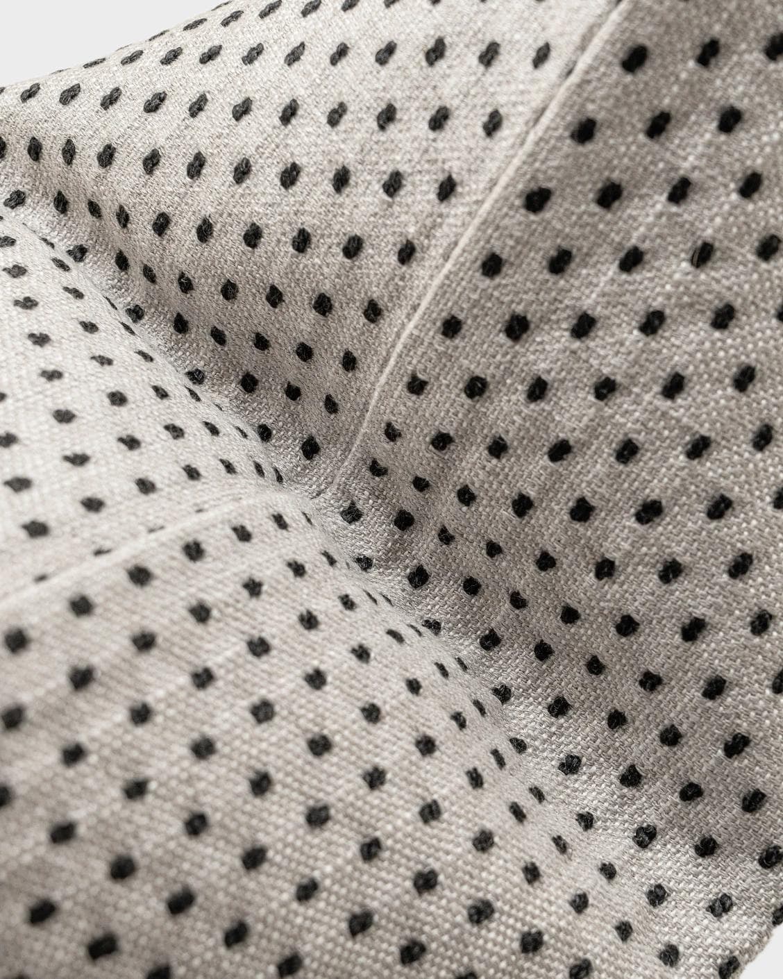 Dotty Steele cushion in grey, shown in a product close-up as image 1