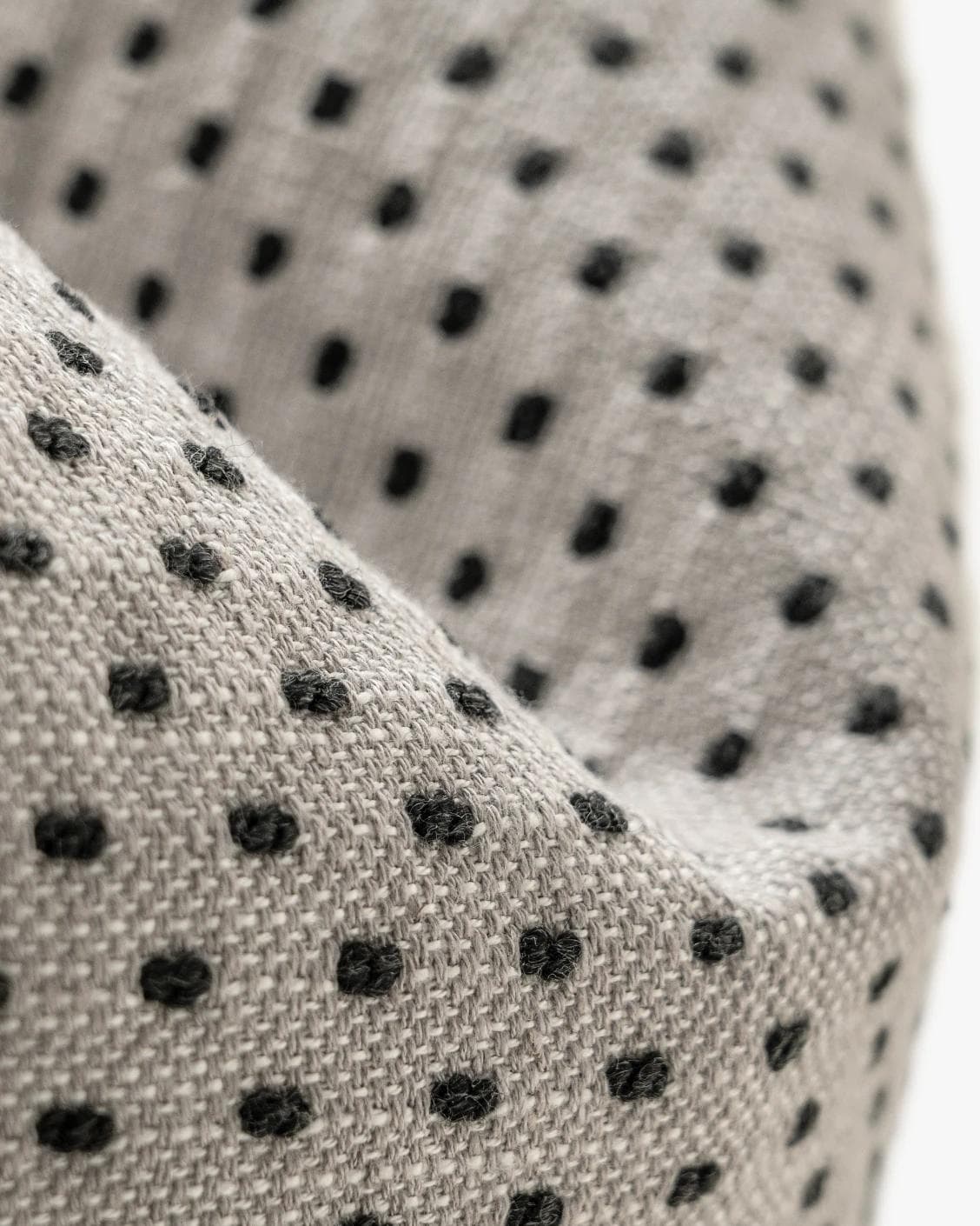 Dotty Steele cushion in grey, shown in a product close-up as image 9