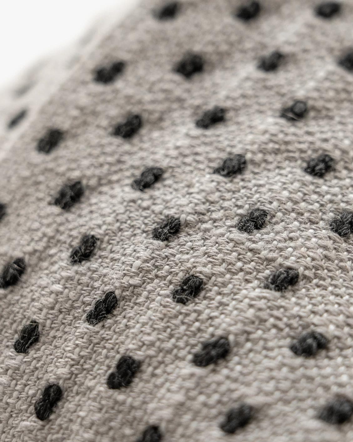 Dotty Steele cushion in grey, shown in a product close-up as image 10