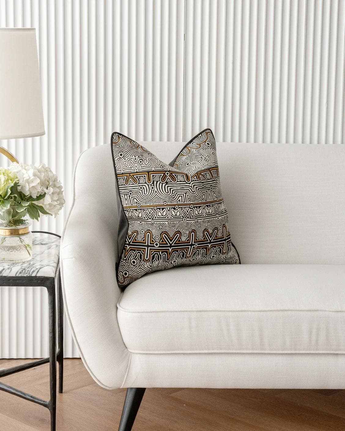 Edda Hodler cushion in black and silver, shown in a lifestyle front view as image 1