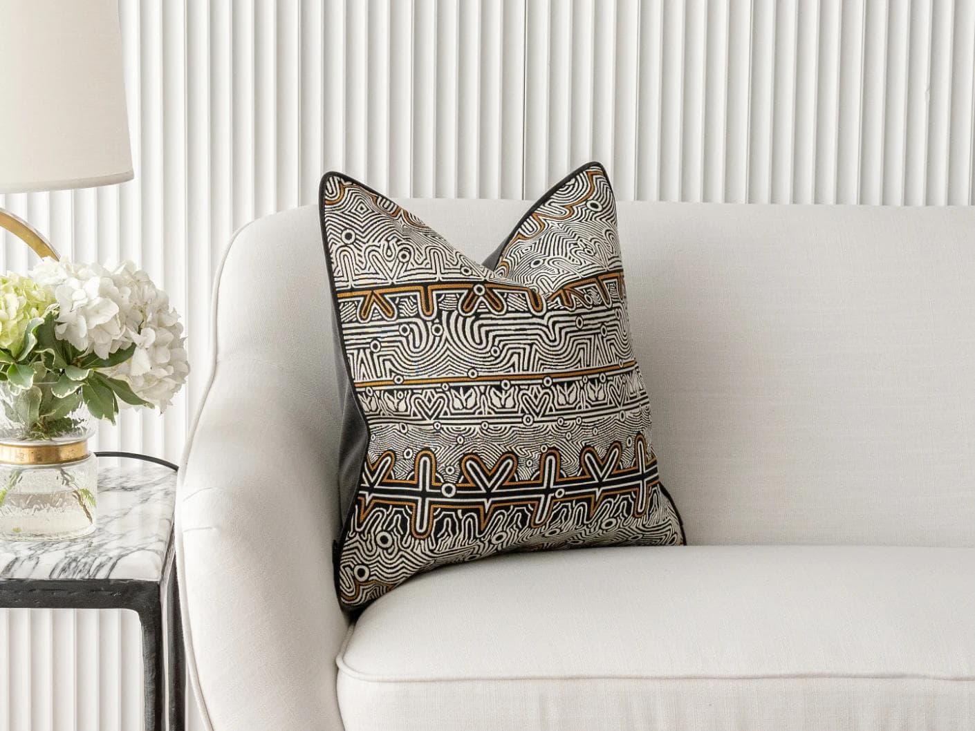 Edda Hodler cushion in black and silver, shown in a lifestyle front view as image 1