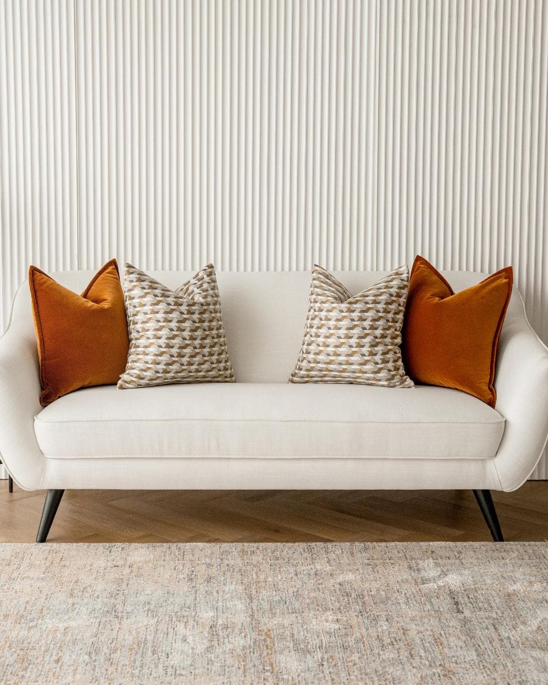 Elda Bundle cushion in rust, shown in a lifestyle front view as image 4