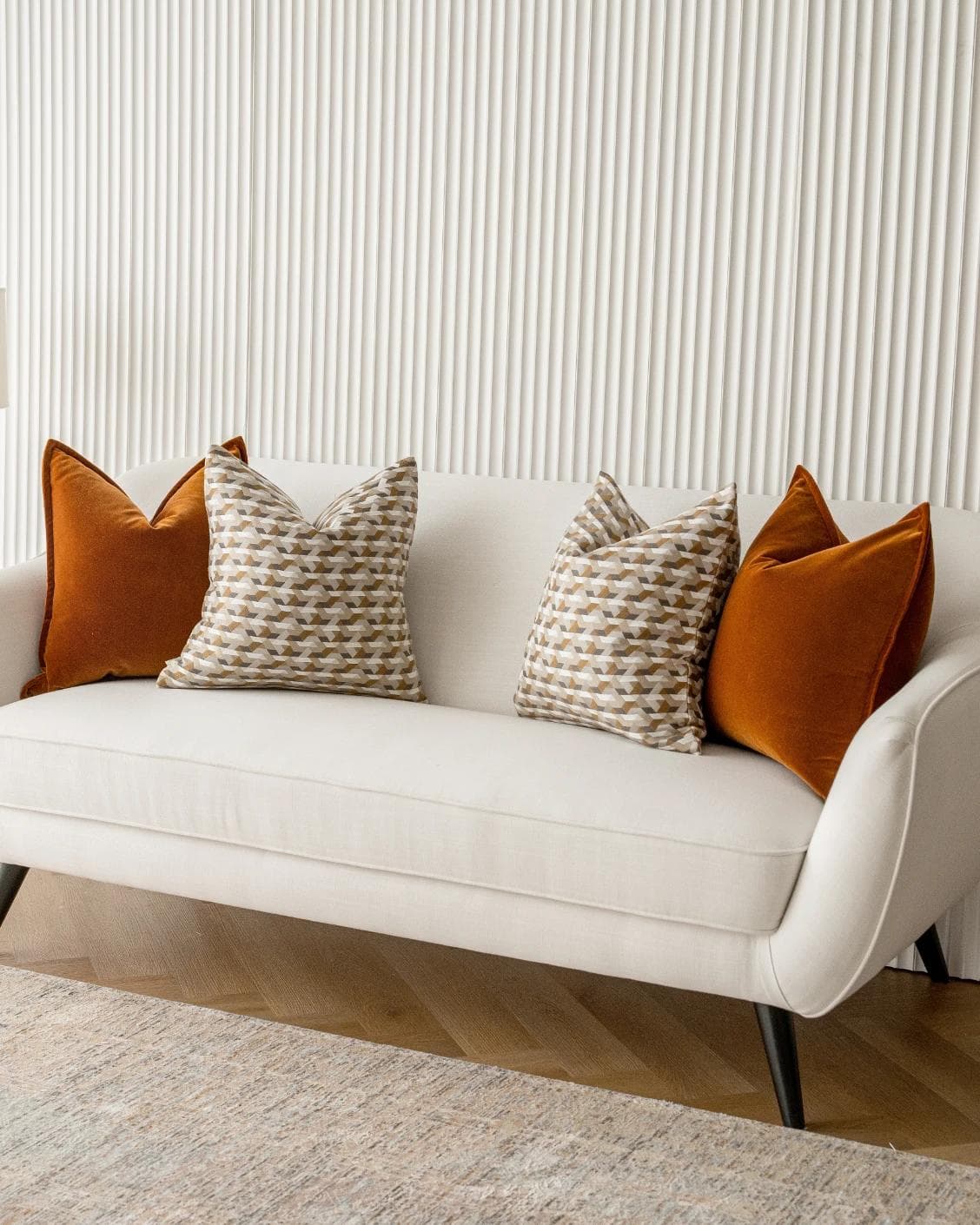 Elda Bundle cushion in rust, shown in a lifestyle right view as image 2