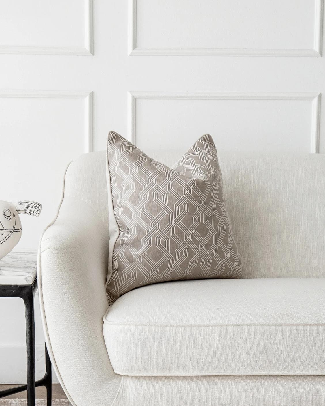 Elena Bianca cushion in beige and white, shown in a lifestyle front view as image 5