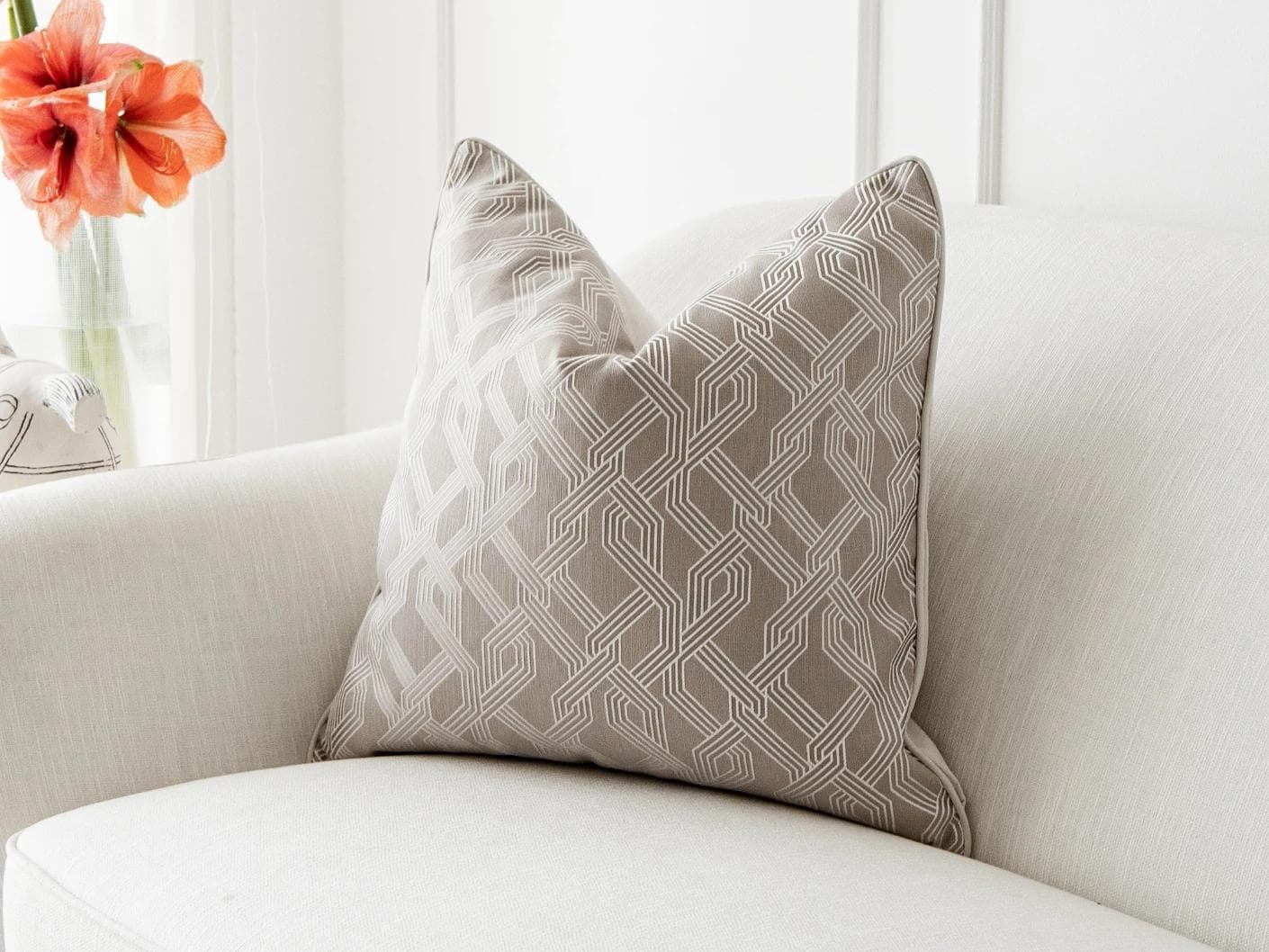 Elena Bianca cushion in beige and white, shown in a lifestyle front view as image 2