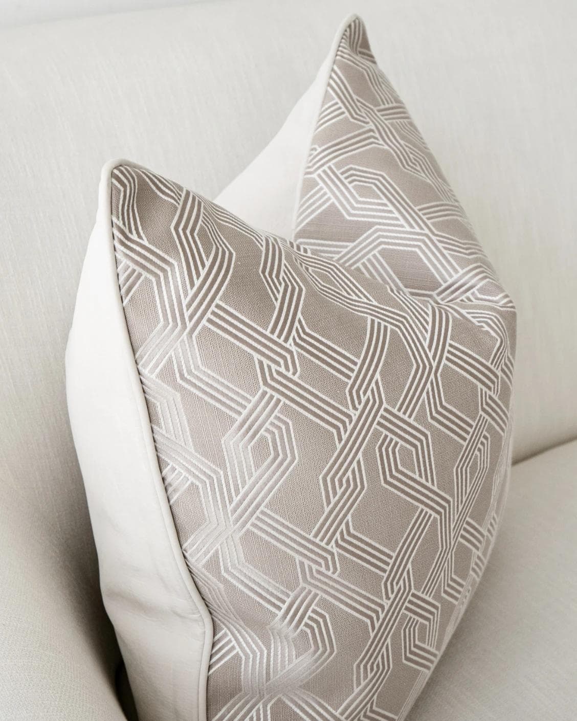 Elena Bianca cushion in beige and white, shown in a lifestyle left view as image 6