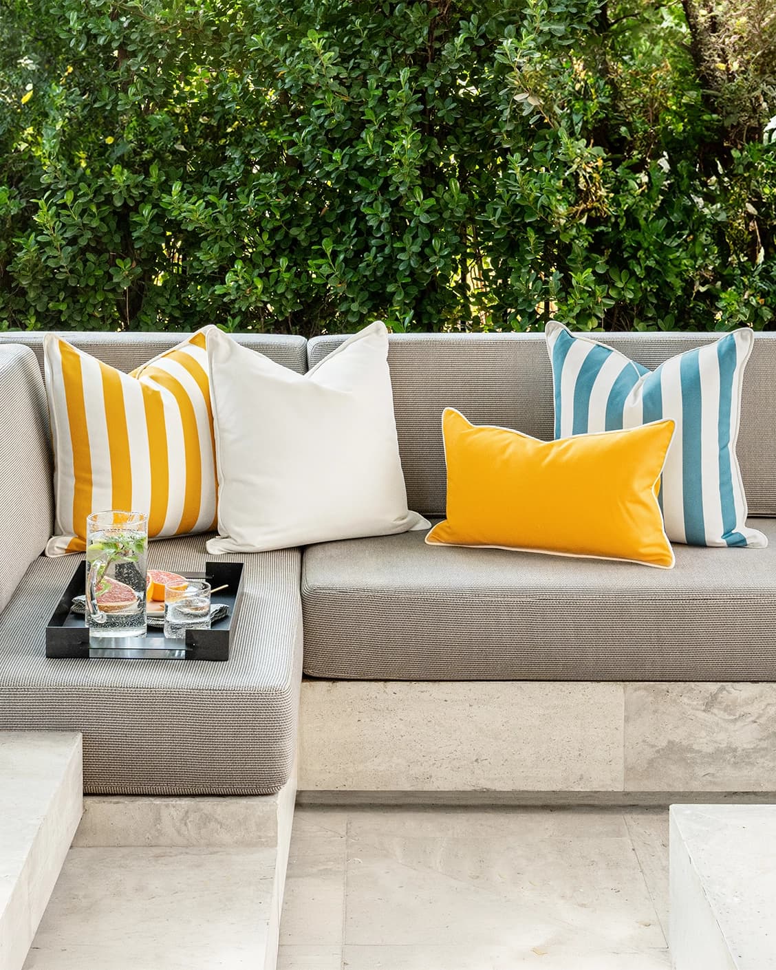 Elio Bundle cushion in turquoise, yellow and ivory, shown in a lifestyle left view as image 2